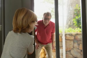 Dziadek i wnuk bawiący się w kryjówkę w wygodnym domu