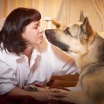 Dorosła dojrzała kobieta z dużym pasterzem w pokoju z białą koszulką z dziewczyną i spokojnym, przytulnym wieczorem