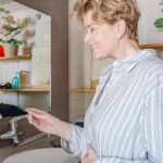 Woman smiling holding pregnancy test with positive result