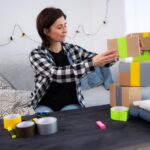 Girl prepares packages for delivery representing a small business at home