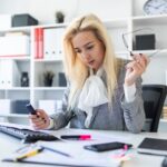 Młoda dziewczyna w biurze pracuje z markierem i dokumentami.